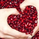 pomegranate heart pomegranate seeds hands making a heart, weight loss and wellness solutions