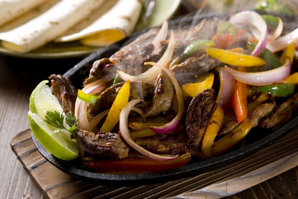 Steak Fajitas in a skillet, sizzling, weight loss and wellness solutions, san antonio texas